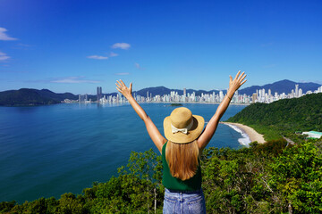 Excited carefree woman raising arms on top view cityscape. Vitaly people. Leisure activity....