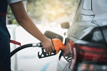 Gasoline being refilled at a petrol station. Refueling Diesel fuel is used to power a car.