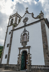 Fototapeta na wymiar Perspective of the facade and bell tower of the church of Santa Ana in Furnas, São Miguel Azores PORTUGAL
