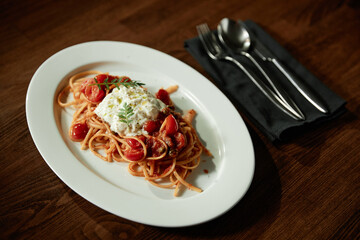 Close-up of pasta on the plate on table serving for lunch in the restaurant