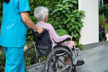 Caregiver help and care Asian senior or elderly old lady woman patient sitting on wheelchair to...