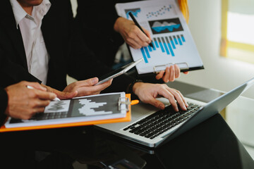 Young colleagues having great business conversations in a modern coworking office blurry background. 