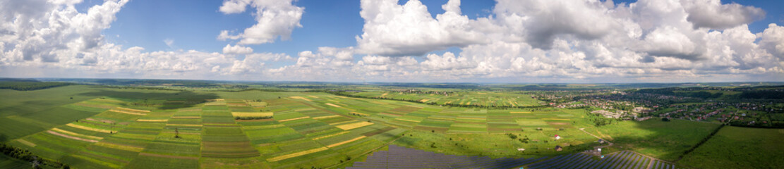 Fototapeta na wymiar Aerial landscape view of green cultivated agricultural fields with growing crops on bright summer day