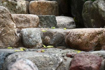 Garden original ladder with steps of any form. It is made of a natural stone of the average size. View of steps in front.