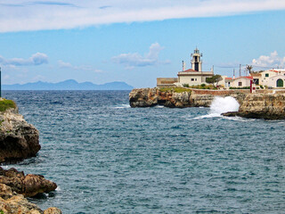 Scenic view of bay at Spanish island Menorca with lighthouse in the background on a sunny spring...
