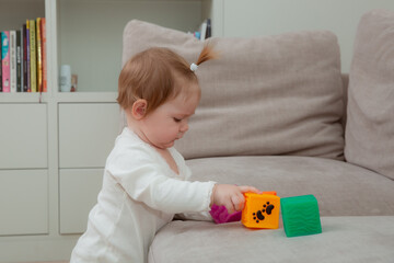 baby girl at home playing dice, child development