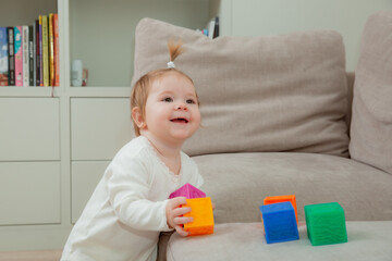 baby girl at home playing dice, child development