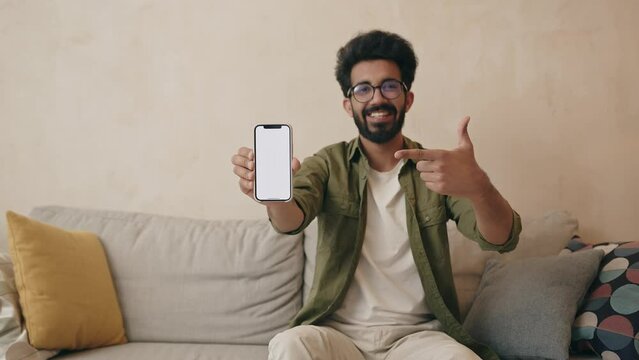 Happy guy showing smartphone screen, pointing finger on blank display  Generative AI
