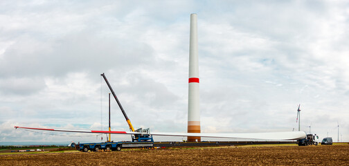 Wind turbine under construction. Blade for wind turbines close up. Special transport of a blade for...