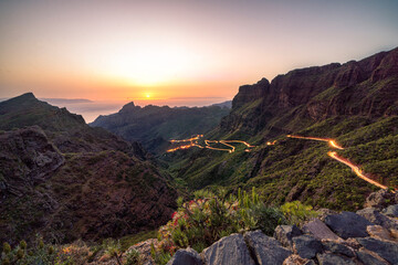 Golden hour sunset image of winding road leading to the village of Masca in dramatic landscape on...