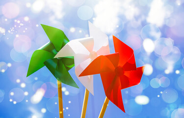 paper windmill in italian flag color, national Italy background. happy republic day Italy in italian. 	