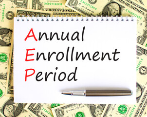 AEP symbol. Concept words AEP Annual enrollment period on beautiful white note. Dollar bills. Beautiful background from dollar bills. Medical and AEP Annual enrollment period concept. Copy space.