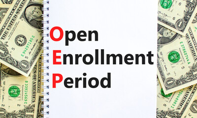 OEP symbol. Concept words OEP Open enrollment period on beautiful white note. Dollar bills....