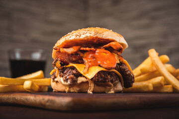 Amazing American traditional smash burger with melted cheddar cheese, bacon, grilled onions and sauce.