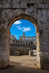 Pula Arena with View of Tower and Blue Sky. Vertical Roman Amphitheater Arch in Croatia during Summer Travel.