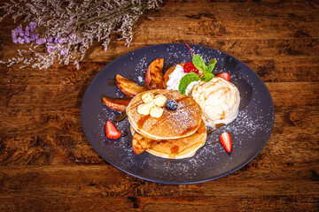 Pancakes with fresh with Ice Cream on a wood background