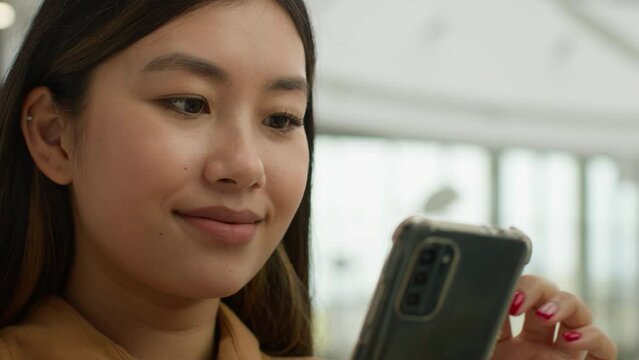 Close up smiling Asian chinese japanese woman portrait multiracial girl businesswoman read social media smartphone screen use mobile phone in office korean ethnic female lady student Generative AI