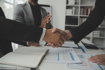 Team of business people working together in the meeting room office, teamwork background charts and...