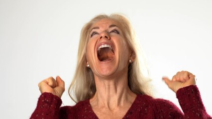 Closeup of mature woman anticipating great success, very happy with hands up in winner gesture, isolated on solid white background. Closeup portrait of model in studio. Generative AI