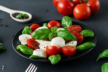 Close-up of  Salad Caprese with tomato, mozzarella and basil. Italian food