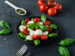 Close-up of  Salad Caprese with tomato, mozzarella and basil. Italian food