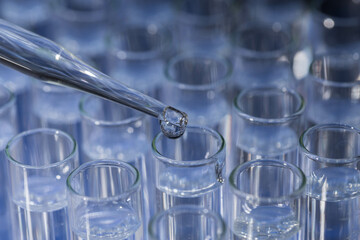 Pipette dropping fluid into test tube