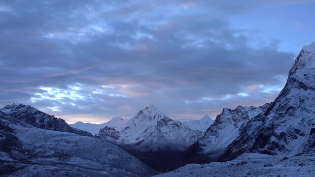 Ama Dablam Himalaya mountain with other peaks, sunset
Beautiful dramatic purple and blue cloudy sunset over snow covered,2023 
