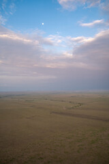 Sunrise aerial view of the Masaai Mara Reserve in Kenya Africa. Vast, desolate landscape