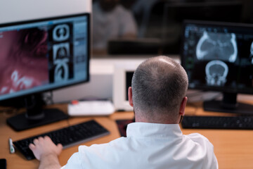 the patient undergoes computed tomography in the clinic the radiologist monitors the procedure and the results of the scan
