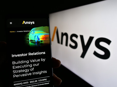 Stuttgart, Germany - 04-27-2023: Person holding smartphone with webpage of US simulation software company Ansys Inc. on screen in front of logo. Focus on center of phone display.