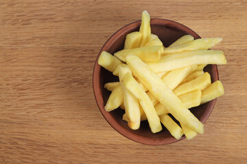french fries, fried potatoes on wooden background. copy space for text