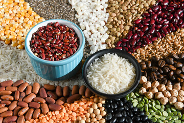 Bowl with raw white rices and beans on various seeds grain