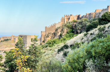 Fototapeta na wymiar View of Sagunto Castle. Ruins walls of the Fortress Castle at the town of Sagunto, near Valencia in Spain. Fortress Castillo in Mountains hills. Fort on mountain.