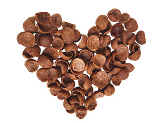 Sweet chocolate cereal corn flakes pile in a heart shape. Healthy fiber breakfast concept, nutrition snack. Top view, Isolated on white background.