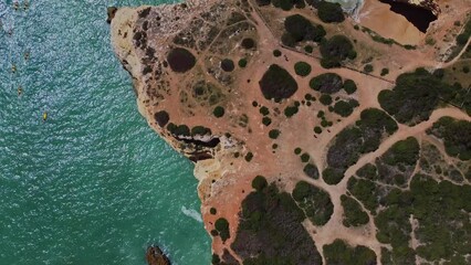 4K Drone. Rugged rocky cliffs, beach, sandy coast ocean ocean waves Ponta Da Piedade. Algarve. Portugal. 20 april 2023