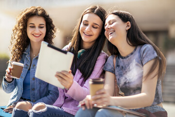 Three collage girls studying outside