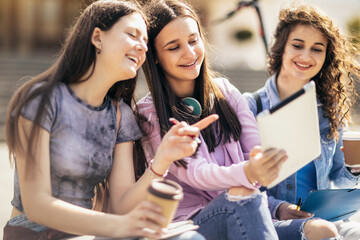 Three collage girls studying outside
