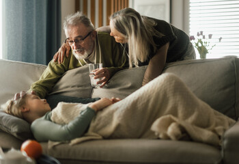 Grandparents taking care of their sick granddaughter.