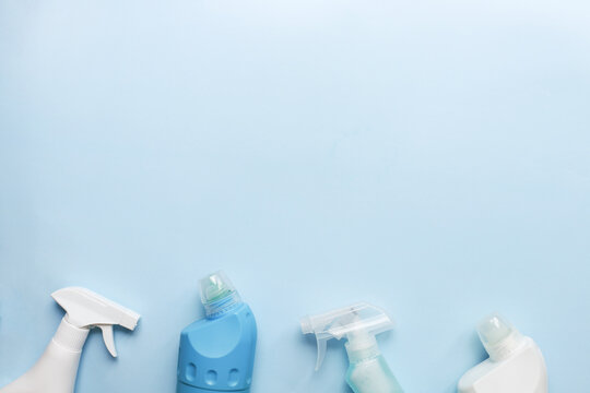 Cleaning tool mockup. Flat lay cleaning products on a blue background. Sprays and bottles for cleaning