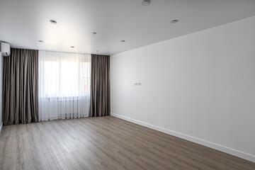 empty room without furniture with white walls and ceiling, curtains