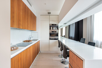kitchen interior, wooden facades, induction cooker, sink, oven in the cabinet