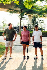 Friend support Friend with a prosthetic leg while exercising outdoor. People walking together on park outdoor. Exercise walking  woman with prosthetic leg and friend support together in  park outdoor