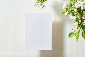Mockup invitation or blank greeting card with spring flowers on a light background