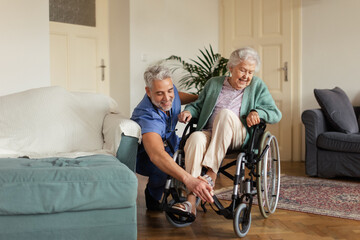 Fototapeta na wymiar Caregiver doing regular check-up of senior woman in her home.