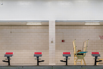 Starting block at a public interior swimming pool / natatorium sports facility.