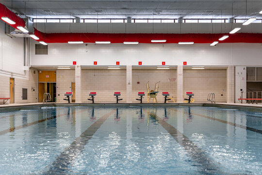 Starting block at a public interior swimming pool / natatorium sports facility.