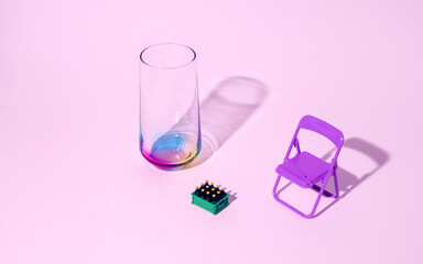 Multicolored glass, garden chair and bottle crate on a pink background. Minimal horizontal composition, summer refreshment concept