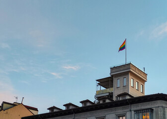 Fototapeta na wymiar LGBT flag hangin on top of classical architecture building in Madrid city center for pride month
