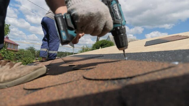 Laying of a soft roof. Construction works at height.