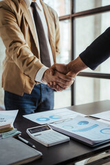 Asian male interviewer and interviewee shaking hands for job interview Businessmen shaking hands in modern office Greeting agreement concept. © Kritdanai